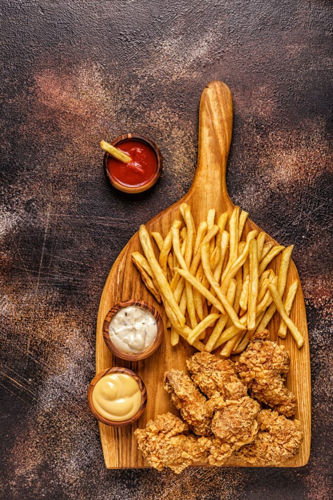 Fried chicken wings with french fries.